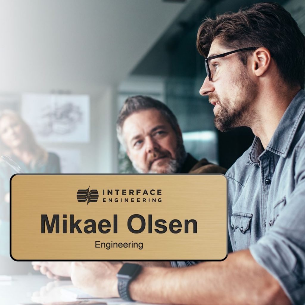 Engineer with an engraved logo name tag.