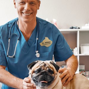 Veterinarian with a custom shaped dog's head name tag.